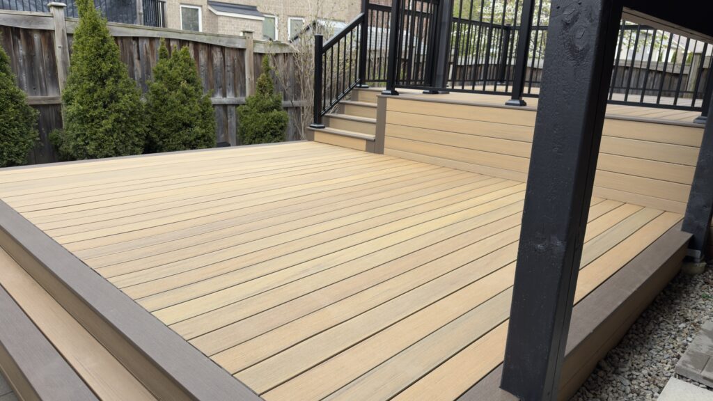 Black aluminum deck railing installed on multi-level backyard deck with gazebo in Ontario