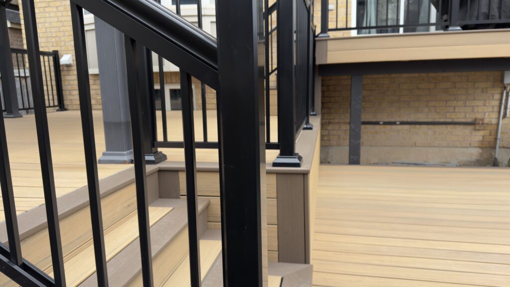 Durable black aluminum railings surrounding elevated composite deck and gazebo area