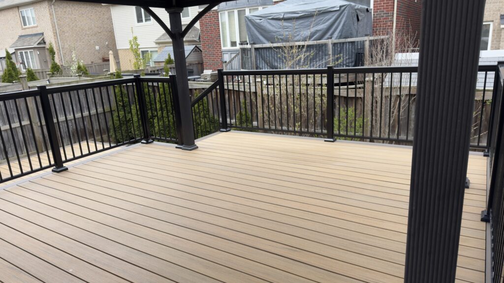 Stylish black metal deck railings paired with composite deck and covered gazebo structure