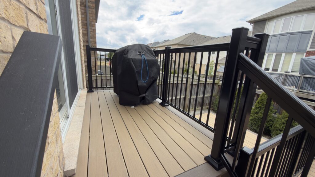Modern outdoor deck featuring aluminum safety railings and custom gazebo installation